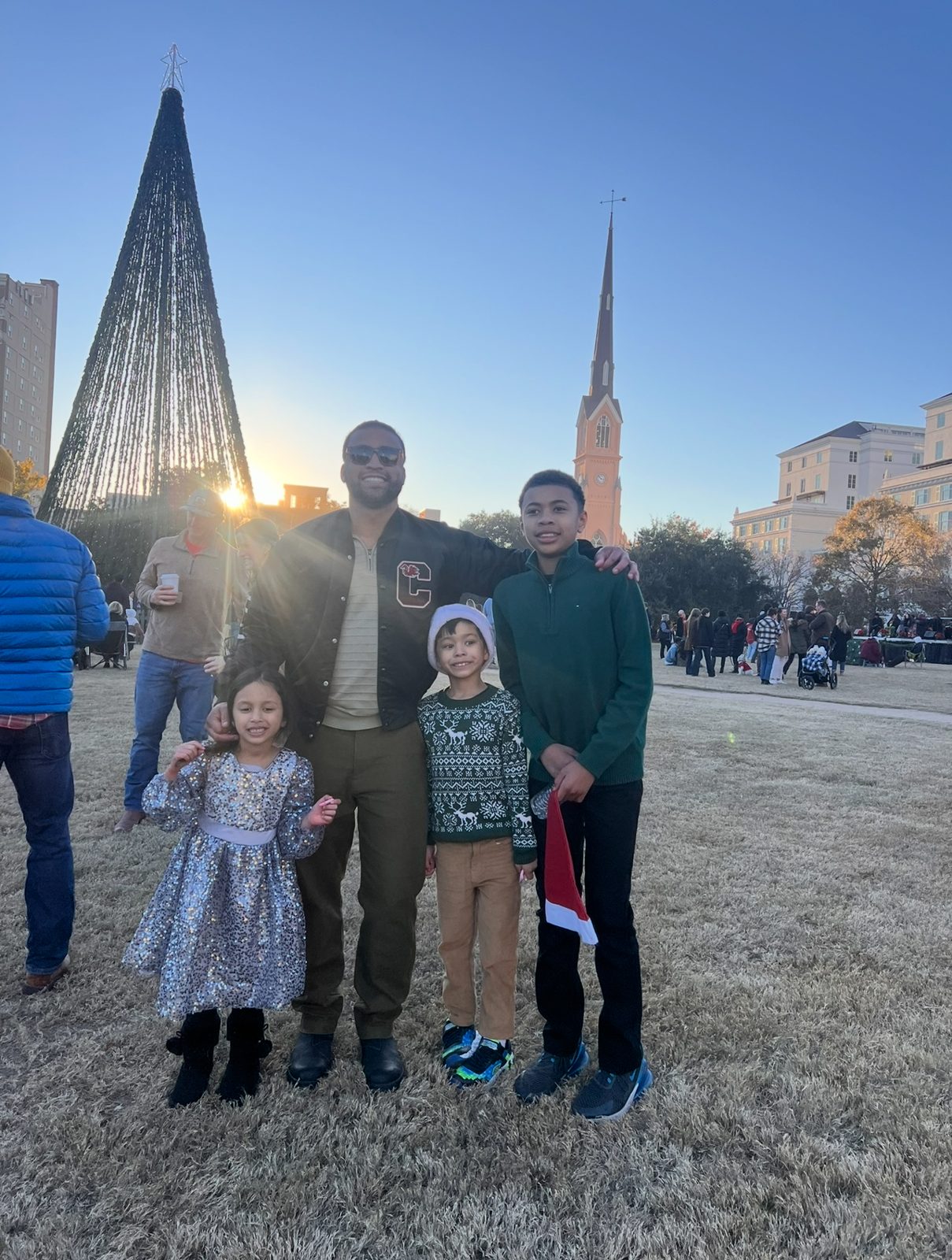 Om Jimmy with his nephews and niece at a community holiday event